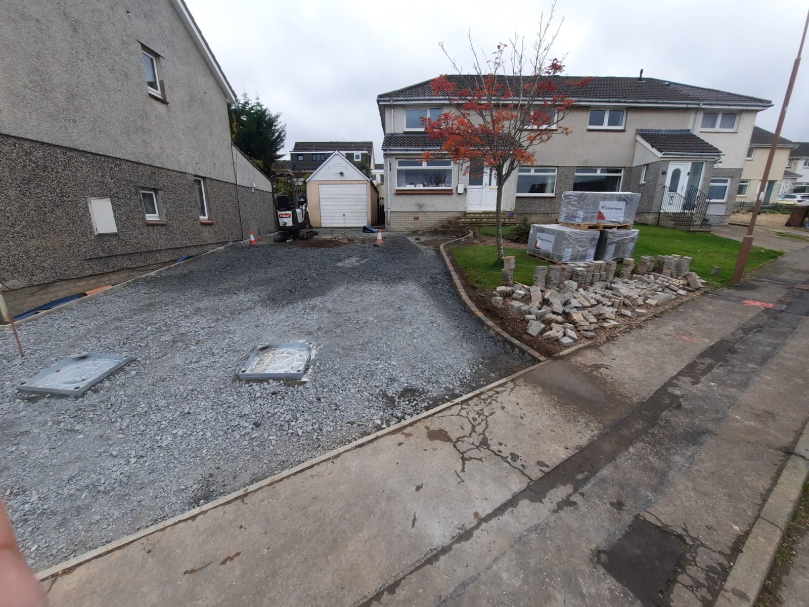Concealed drain lid in Tobermore block paving driveway near Currie